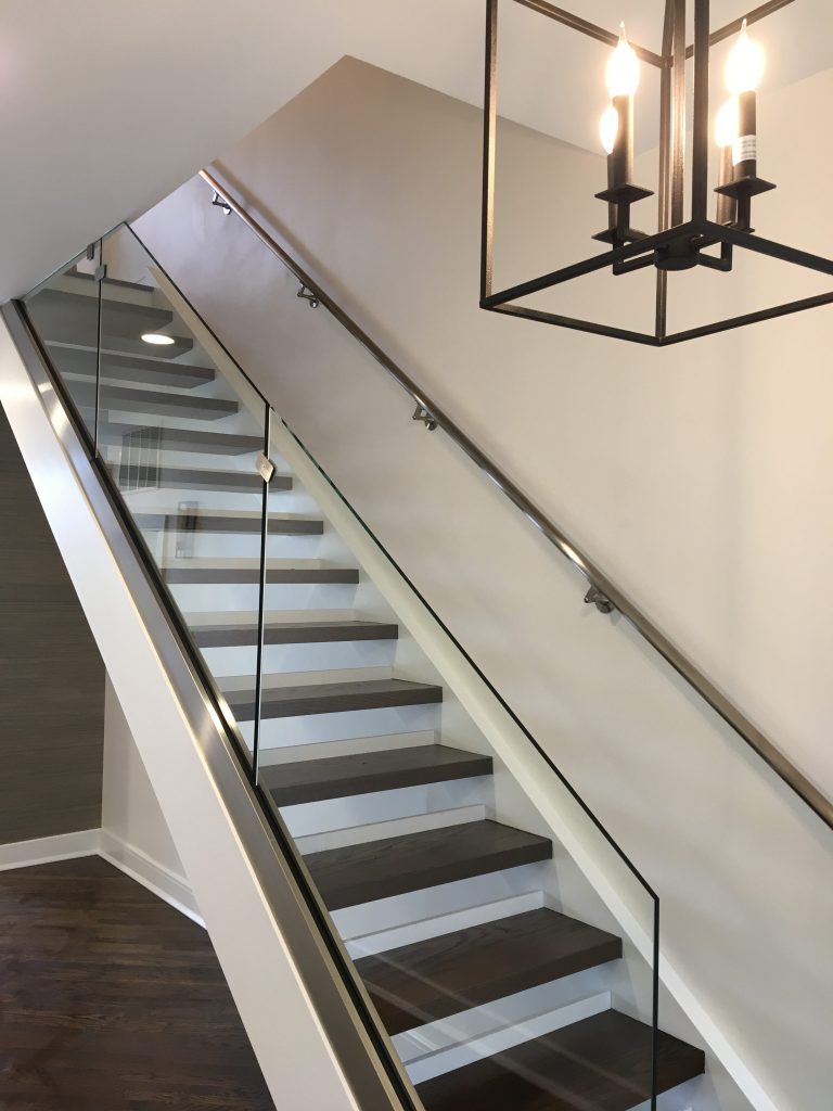 Custom staircase with Glass railing and Steel handrail