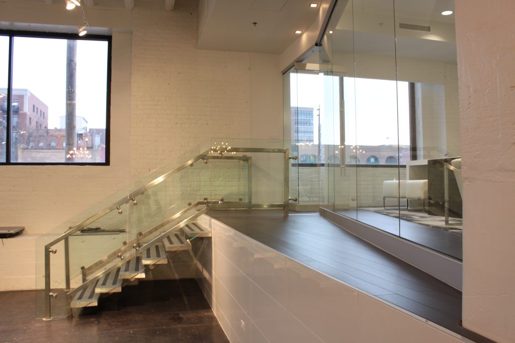 Elevated Executive Office with Metal Staircase and Glass Enclosure