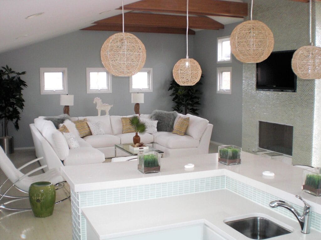 Chicago entertainment loft interior with custom bar white sectional seating glass mosaic fireplace and woven pendant lighting by Jordan Guide Design