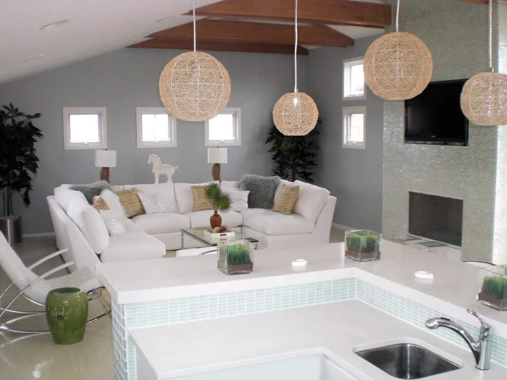 Chicago entertainment loft interior with custom bar white sectional seating glass mosaic fireplace and woven pendant lighting by Jordan Guide Design