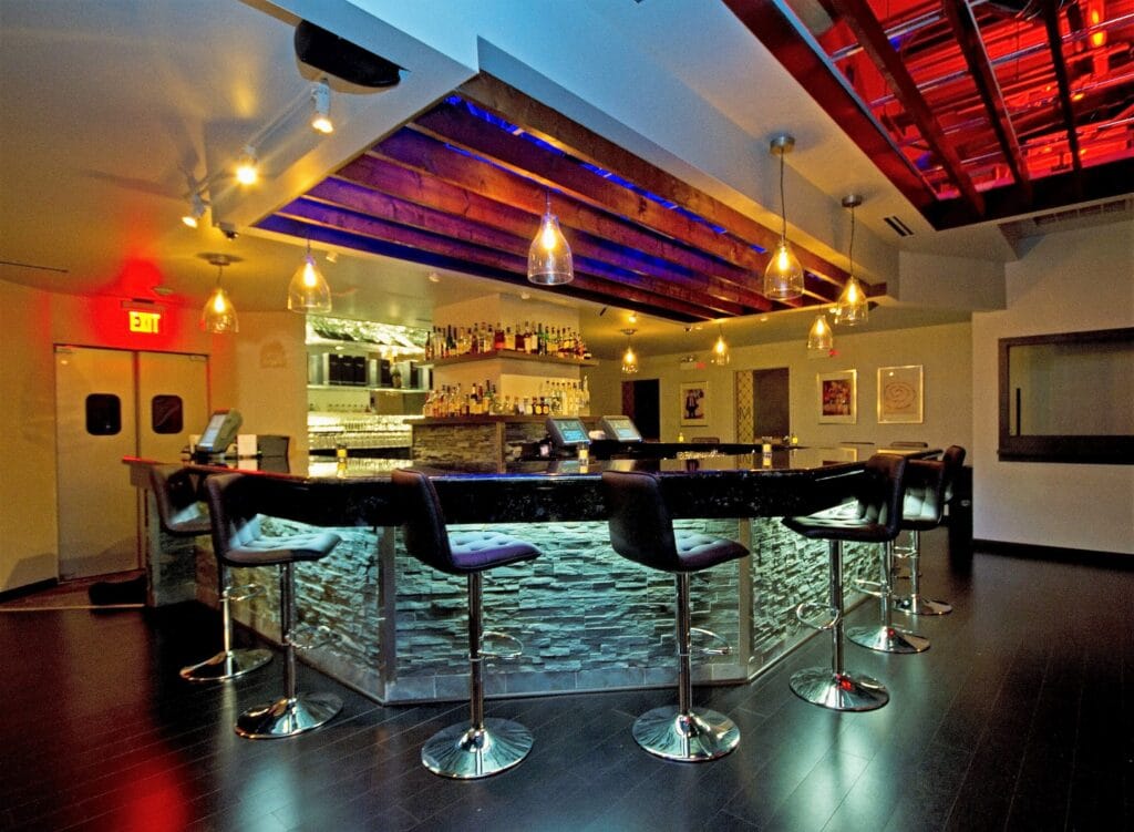 Chicago ultra lounge bar interior designed by Jordan Guide Design featuring custom stone bar LED ceiling lighting plush seating and modern nightlife atmosphere