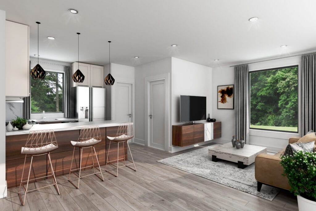 Modern open-concept kitchen and living area with large island, pendant lighting, and expansive picture windows overlooking a wooded lot, designed by Jordan Guide Design
